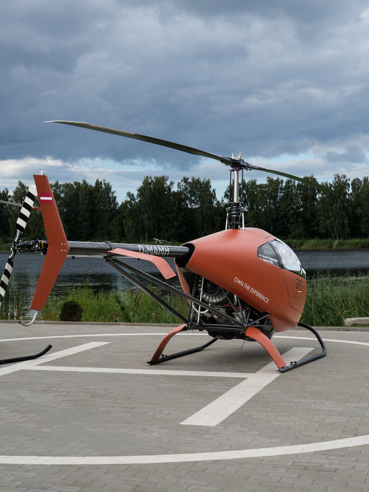 HungaroCopter HC-02 on the helipad, lake behind